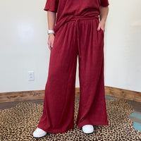 maroon outfit with wide-leg pants 