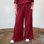 maroon outfit with wide-leg pants 