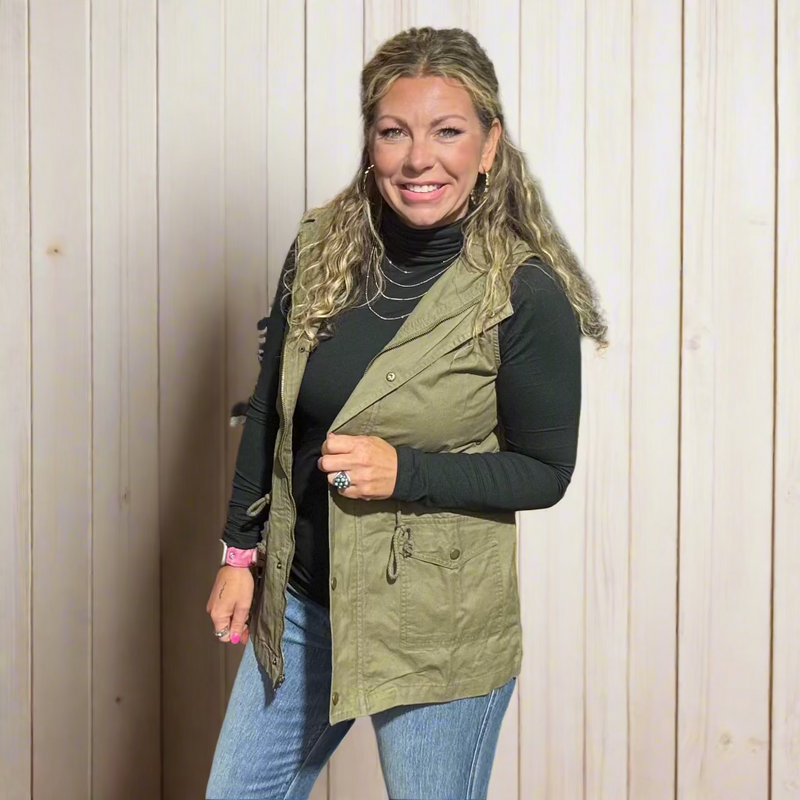 Woman standing in a clothing store with clothes and a yellow chair in the background
