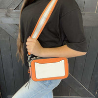 orange crossbody bag with a white patch