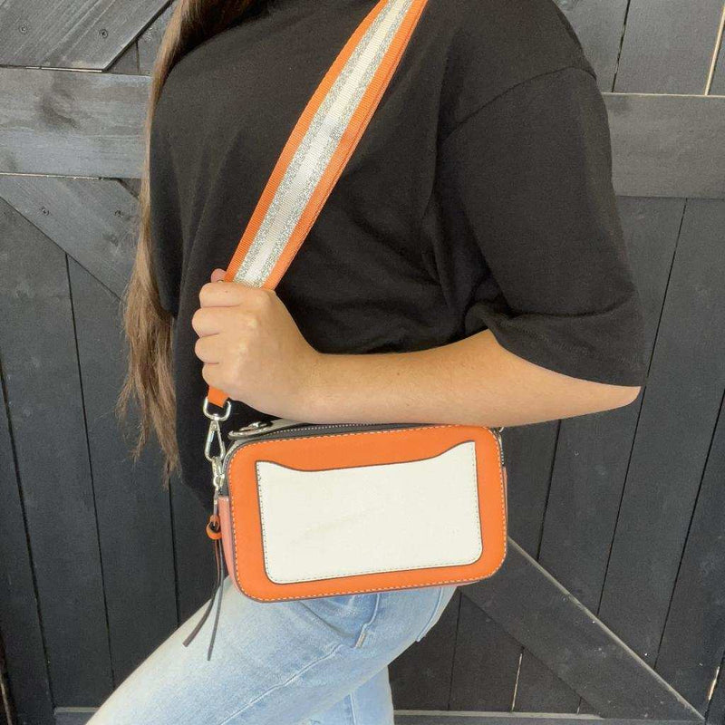 orange crossbody bag with a white patch