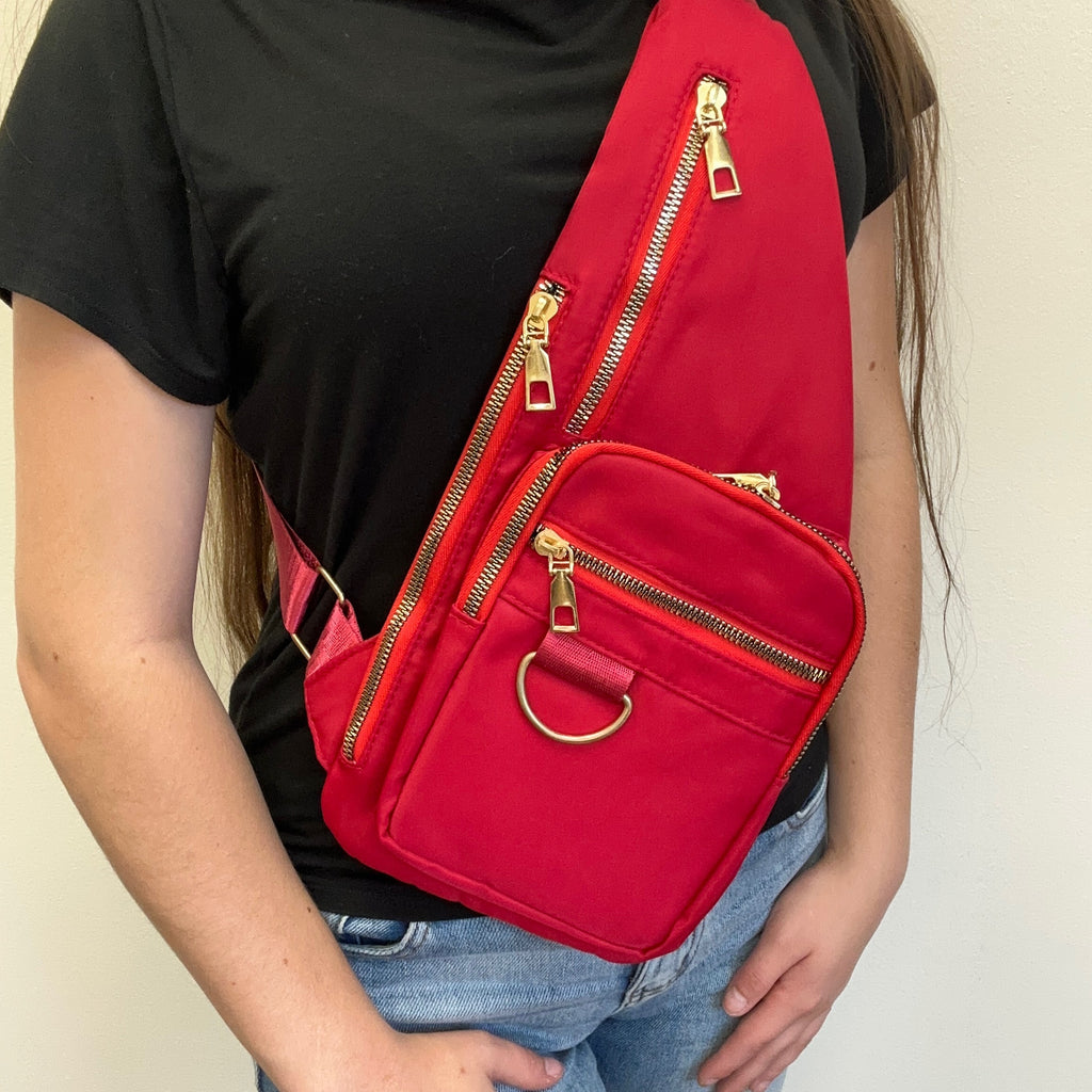  red sling bag with gold zippers 