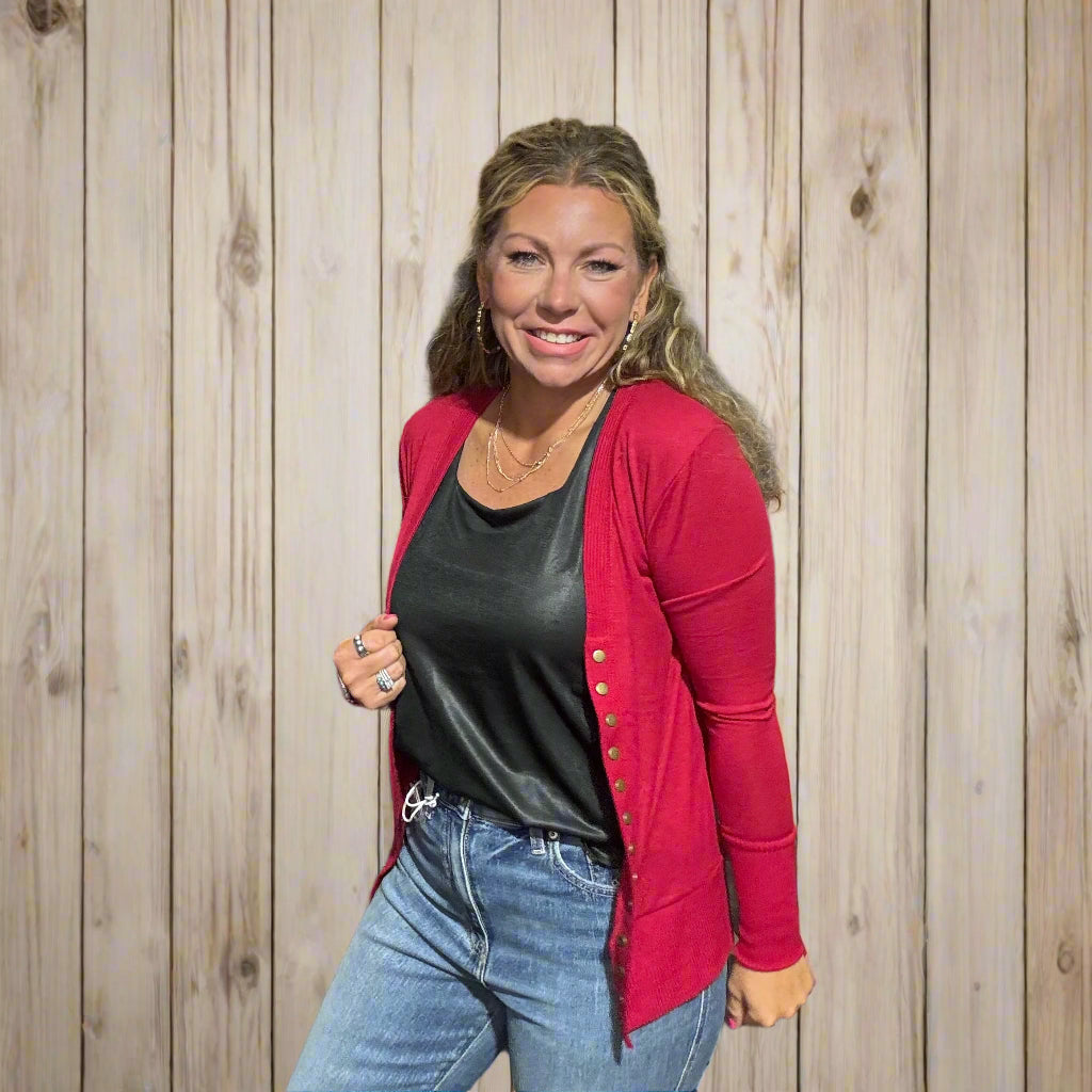 Woman standing in front of a clothing rack with a 'Country Ace' sign in the background